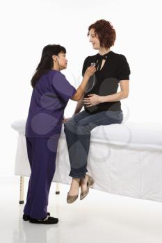 Royalty Free Photo of a Pregnant Woman Having Her Vital Signs Checked By a Nurse
