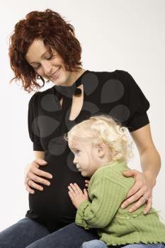 Royalty Free Photo of a Pregnant Mother Hugging Her Daughter