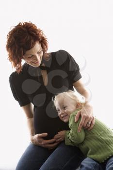 Royalty Free Photo of a Pregnant Mother Hugging Her Daughter