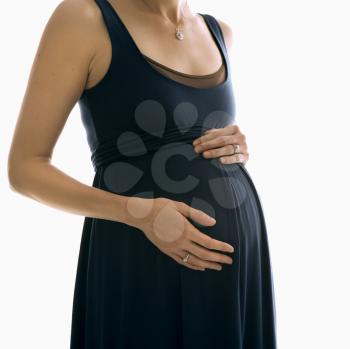 Royalty Free Photo of a Pregnant Woman With Hands on Her Belly