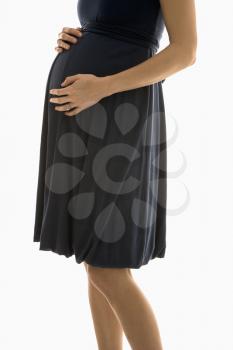 Royalty Free Photo of a Pregnant Woman With Her Hands on Her Belly