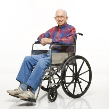 Royalty Free Photo of an Elderly Man Sitting in a Wheelchair Smiling