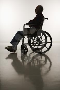 Royalty Free Photo of an Elderly Man Sitting in a Wheelchair 