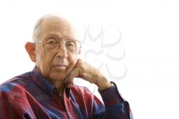 Royalty Free Photo of an Elderly Man With His Face Propped on Hand