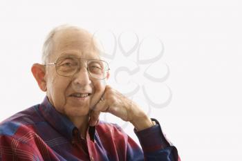 Royalty Free Photo of a Smiling Elderly Man With His Face Propped on His Hand