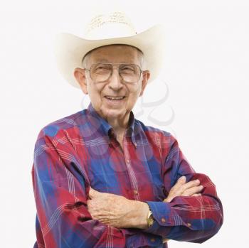 Royalty Free Photo of a Smiling Elderly Man Wearing a Plaid Shirt and Cowboy Hat With Arms Crossed