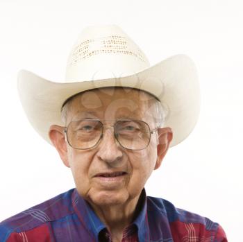 Royalty Free Photo of a Smiling Elderly Man Wearing a Plaid Shirt and Cowboy Hat