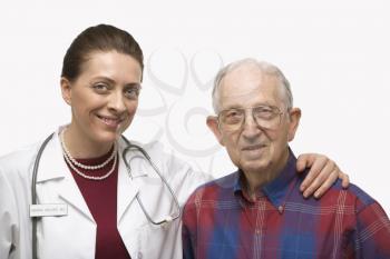 Royalty Free Photo of a female doctor with arm around elderly Caucasian male