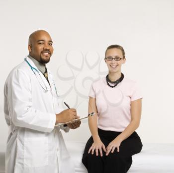 Royalty Free Photo of a Doctor Consulting With a Female Patient