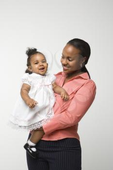 Royalty Free Photo of an African American Woman Holding an Infant Girl