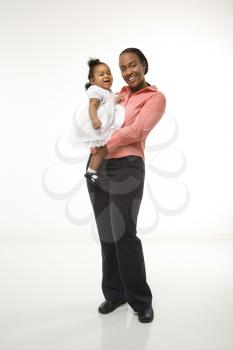 Royalty Free Photo of a Mother Holding Her Baby Daughter Smiling