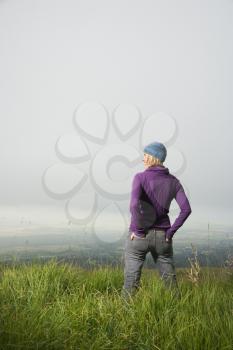 Royalty Free Photo of a Woman Standing Alone in a Field