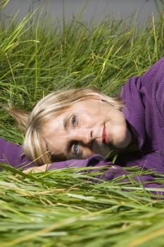 Royalty Free Photo of a Middle-aged Woman Lying in the Grass