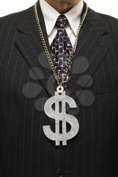 Royalty Free Photo of a Middle-Aged Businessman Wearing a Chain Necklace With an Over Sized Dollar Sign