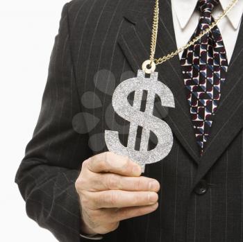Royalty Free Photo of a Middle-Aged Businessman Wearing a Chain Necklace With an Over Sized Dollar Sign
