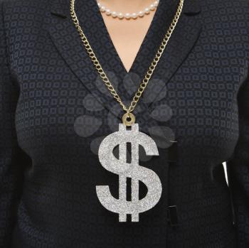 Royalty Free Photo of a Businesswoman Wearing a Dollar Sign Necklace