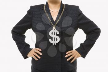 Royalty Free Photo of a Businesswoman Wearing a Dollar Sign Necklace