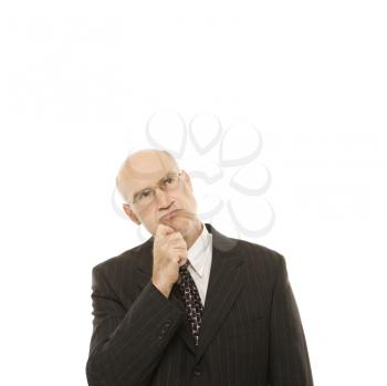 Royalty Free Photo of a Middle-Aged Businessman With Hand to His Chin Looking Thoughtful