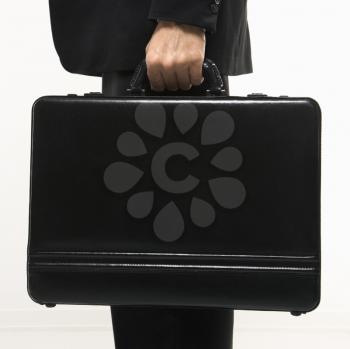 Royalty Free Photo of a Man's Hand Holding a Briefcase