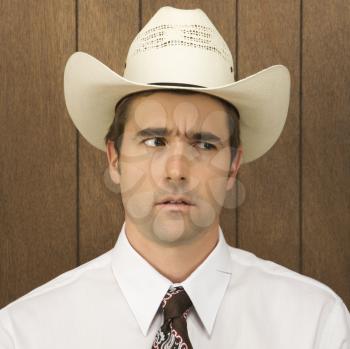 Royalty Free Photo of a Male Wearing a Cowboy Hat Looking Off to the Side
