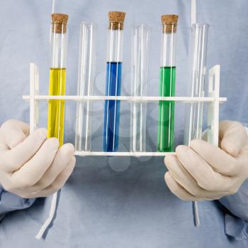 Royalty Free Photo of a Close-up of male surgeon's hands holding test tube tray.