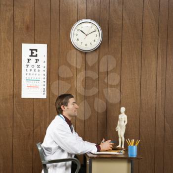 Royalty Free Photo of a Doctor Sitting at a Desk