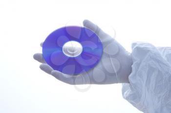 Royalty Free Photo of a Hand Wearing a Latex Glove Holding a CD