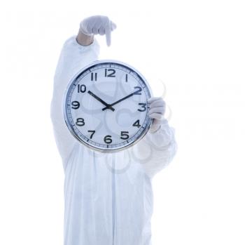 Royalty Free Photo of a Man in a Biohazard Suit Holding a Clock in Front of His Face