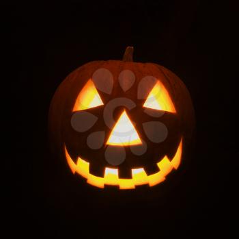 Royalty Free Photo of a Carved Halloween Pumpkin Glowing in The Dark