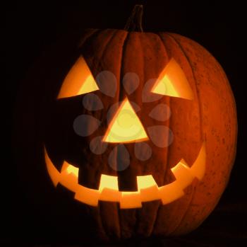 Royalty Free Photo of a Carved Halloween Pumpkin Glowing in The Dark