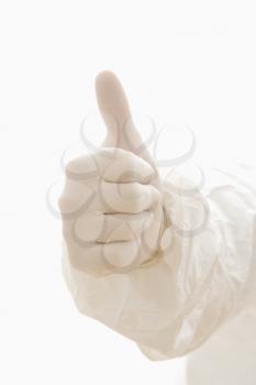 Royalty Free Photo of a Hand Wearing a White Rubber Glove Giving a Thumbs Up
