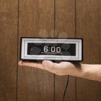 Royalty Free Photo of a Man Holding a Retro Alarm Clock
