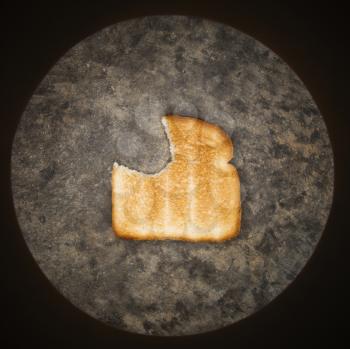 Royalty Free Photo of a Slice of Toast With a Bite Missing