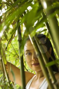 Portrait of Asian American woman in bamboo forest in Maui, Hawaii.