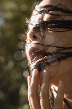 Royalty Free Photo of a Female With Wet Hair in Her Mouth