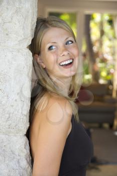 Royalty Free Photo of a Woman Looking Over Her Shoulder Smiling