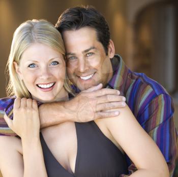 Royalty Free Photo of a Couple Embracing and Smiling