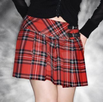 Royalty Free Photo of a Caucasian Young Woman Wearing a Short Plaid Skirt