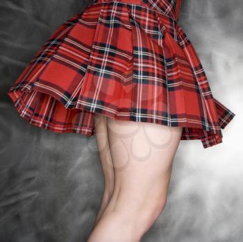 Royalty Free Photo of a Woman Wearing a Billowing Plaid Skirt