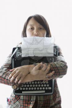 Royalty Free Photo of a Woman Holding a Typewriter