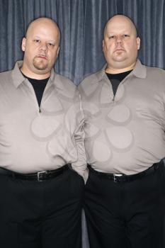 Royalty Free Photo of Identical Twin Men Standing Together