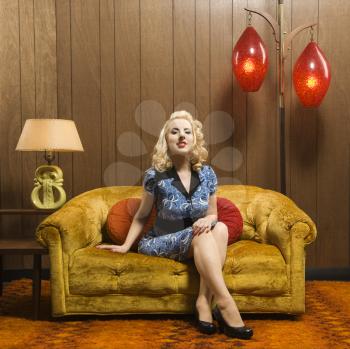 Royalty Free Photo of a Woman Sitting in a Retro Decorated Room
