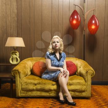 Royalty Free Photo of a Woman Sitting in a Retro Decorated Room