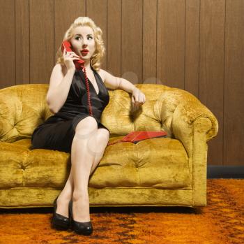 Royalty Free Photo of a Woman Talking on a Red Retro Phone