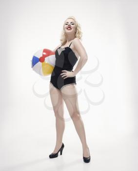 Royalty Free Photo of a Woman Wearing a Swimsuit Holding a Beach Ball
