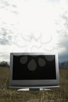 Royalty Free Photo of 
Flat Panel Television Set in a Grassy Field