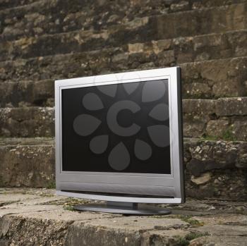 Royalty Free Photo of a Flat Panel Television Set in Front of a Brick Wall