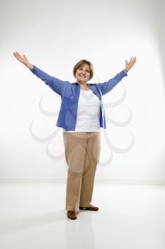 Royalty Free Photo of a Woman Standing With Her Arms Raised