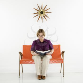 Royalty Free Photo of a Woman Sitting Reading a Book
