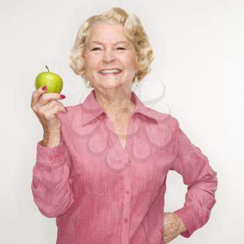 Royalty Free Photo of an Older Woman Holding an Apple